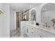 Bathroom featuring double sink vanity, modern fixtures, glass shower and white cabinets at 23 Ocean Dr, Punta Gorda, FL 33950