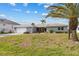 Charming single-story home featuring a well-kept front yard, attached garage and beautiful palm tree at 23 Ocean Dr, Punta Gorda, FL 33950