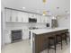 A modern kitchen features white cabinetry, stainless steel appliances, and a large center island at 23 Ocean Dr, Punta Gorda, FL 33950