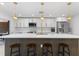 A kitchen featuring a central island with bar seating, stainless steel appliances, and contemporary lighting at 23 Ocean Dr, Punta Gorda, FL 33950