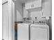 Efficient laundry room with modern washer and dryer, and ample storage at 23 Ocean Dr, Punta Gorda, FL 33950