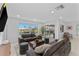 Living room with water views, neutral paint, gray couches, ottomans, and rug at 23 Ocean Dr, Punta Gorda, FL 33950