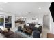 Open-concept living room with modern furnishings connecting to the kitchen and dining area at 23 Ocean Dr, Punta Gorda, FL 33950