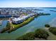 An aerial view of condos with a waterfront view and docks on a sunny day at 2424 Placida Rd # C104, Englewood, FL 34224