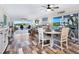 Bright living spaces with wood-look tile, updated dining area, water views, and glass sliding doors at 2424 Placida Rd # C104, Englewood, FL 34224
