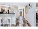 Hallway with wood-look tile and leading to the kitchen and front door provides plenty of natural light at 2424 Placida Rd # C104, Englewood, FL 34224
