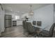 Dining area features modern light fixture and stainless appliances at 2625 Pine Lake Ter # B, Sarasota, FL 34237