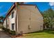 Side exterior view of building and yard with green grass at 2625 Pine Lake Ter # B, Sarasota, FL 34237