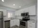 Charming kitchen showcasing stainless steel appliances and light countertops at 2625 Pine Lake Ter # B, Sarasota, FL 34237