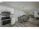 Combined kitchen and dining area with modern stainless appliances and stylish dining set at 2625 Pine Lake Ter # B, Sarasota, FL 34237