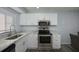 Kitchen features stainless steel appliances and white cabinetry at 2625 Pine Lake Ter # B, Sarasota, FL 34237