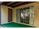 A small outdoor patio with synthetic grass and a sliding glass door at 2625 Pine Lake Ter # B, Sarasota, FL 34237