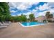 Relax by the community pool surrounded by lush greenery and comfortable lounge chairs at 2625 Pine Lake Ter # B, Sarasota, FL 34237