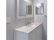 Bathroom showcasing a single vanity and a large mirror, with a neutral color scheme at 2720 60Th Avenue W Dr # D, Bradenton, FL 34207