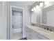 Bright bathroom featuring double vanity with marble countertop and a shower-tub combo at 2720 60Th Avenue W Dr # D, Bradenton, FL 34207
