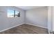 Neutral bedroom with modern wood-look flooring and a window for plenty of natural light at 2720 60Th Avenue W Dr # D, Bradenton, FL 34207
