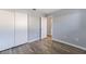 Bedroom with wood-look flooring, closet, and neutral paint for a bright, fresh look at 2720 60Th Avenue W Dr # D, Bradenton, FL 34207