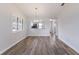 Open dining area with wood floors, neutral walls, and a view into the kitchen at 2720 60Th Avenue W Dr # D, Bradenton, FL 34207