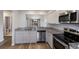 Well-equipped kitchen with granite counters, stainless appliances, and a pass-through to the living area at 2720 60Th Avenue W Dr # D, Bradenton, FL 34207