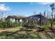 View of the home's screened pool area, lawn, and neatly landscaped yard at 2877 Sultan Ct, North Port, FL 34286