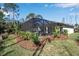 The home's screened pool area is nicely landscaped with tropical foliage at 2877 Sultan Ct, North Port, FL 34286