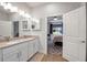 Bright bathroom with double sinks, tile floors, and view of the bedroom at 2877 Sultan Ct, North Port, FL 34286