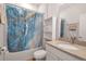 Stylish bathroom with a marble-patterned shower curtain and modern vanity at 2877 Sultan Ct, North Port, FL 34286