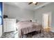 Bright bedroom with a ceiling fan, large window, and neutral-colored bedding at 2877 Sultan Ct, North Port, FL 34286