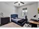 Comfortable bedroom with a stylish blue headboard, desk area, and modern decor at 2877 Sultan Ct, North Port, FL 34286