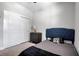 Neat bedroom featuring closet doors and a modern bed with a tufted headboard at 2877 Sultan Ct, North Port, FL 34286