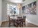 Bright dining room with modern lighting and an attractive city painting at 2877 Sultan Ct, North Port, FL 34286