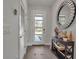 Inviting entryway with a stylish mirror and decorative console table at 2877 Sultan Ct, North Port, FL 34286