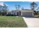 Charming single-story home features neutral paint, well-manicured lawn, and an attached two-car garage at 2877 Sultan Ct, North Port, FL 34286