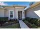 Inviting front entrance with decorative door, manicured landscaping, and a charming walkway at 2877 Sultan Ct, North Port, FL 34286