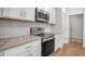 Bright kitchen featuring stainless steel appliances, white cabinetry and light countertops at 2877 Sultan Ct, North Port, FL 34286