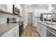 Bright kitchen featuring stainless steel appliances, white cabinetry, a center island and light countertops at 2877 Sultan Ct, North Port, FL 34286