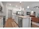 Well-lit kitchen features stainless steel appliances, a center island, and an open design with a view to the living room at 2877 Sultan Ct, North Port, FL 34286