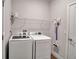 Functional laundry area with a modern washer and dryer and convenient shelving at 2877 Sultan Ct, North Port, FL 34286