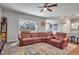 Comfortable living room with large windows, tile floors, and access to the outdoor pool area at 2877 Sultan Ct, North Port, FL 34286