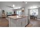 Open concept living room, kitchen, and dining area, with modern pendant lighting and stainless steel appliances at 2877 Sultan Ct, North Port, FL 34286