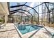 Refreshing screened-in pool area with comfortable lounge chairs and lush landscaping at 2877 Sultan Ct, North Port, FL 34286