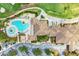 Aerial view of the pool and clubhouse showing the golf course nearby at 324 Whispering Palms Ln, Bradenton, FL 34212