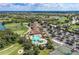 Aerial view of the clubhouse, golf course, pool, and tennis courts in a beautiful community at 324 Whispering Palms Ln, Bradenton, FL 34212