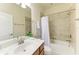 Bathroom with a tub and shower, vanity, mirror and decorative plants at 324 Whispering Palms Ln, Bradenton, FL 34212