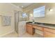 Bright bathroom featuring a glass shower, granite countertop vanity, and neutral tile at 324 Whispering Palms Ln, Bradenton, FL 34212