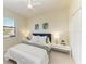 Well-lit bedroom with a queen bed, side tables, closet and large window at 324 Whispering Palms Ln, Bradenton, FL 34212