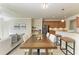 Open dining area with a large wooden table and seating, flowing into the living space at 324 Whispering Palms Ln, Bradenton, FL 34212