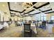 Spacious dining room with elegant tables, chairs, and ample natural light from large windows at 324 Whispering Palms Ln, Bradenton, FL 34212