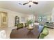 An elegant dining room with green upholstered chairs and a large dark wood table at 324 Whispering Palms Ln, Bradenton, FL 34212