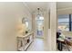 Bright foyer features a stylish console table, decorative mirror, and elegant front door at 324 Whispering Palms Ln, Bradenton, FL 34212